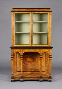 A Continental Burlwood and Ebonized Cabinet on Stand, Height 61 3/4 x width 36 1/4 x depth 17 1/4 inches.