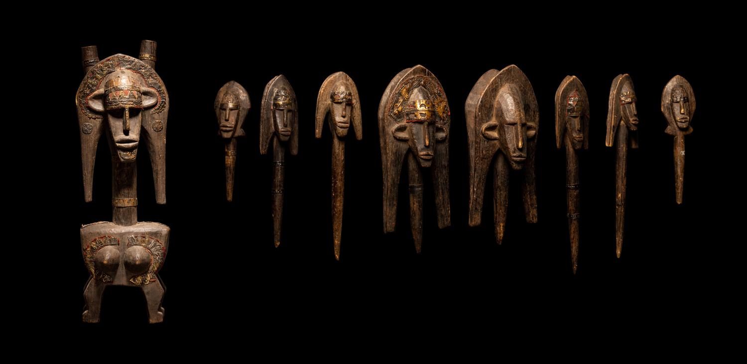 A Bamana Wood Marionette Figure with Eight Wood Puppet Heads
