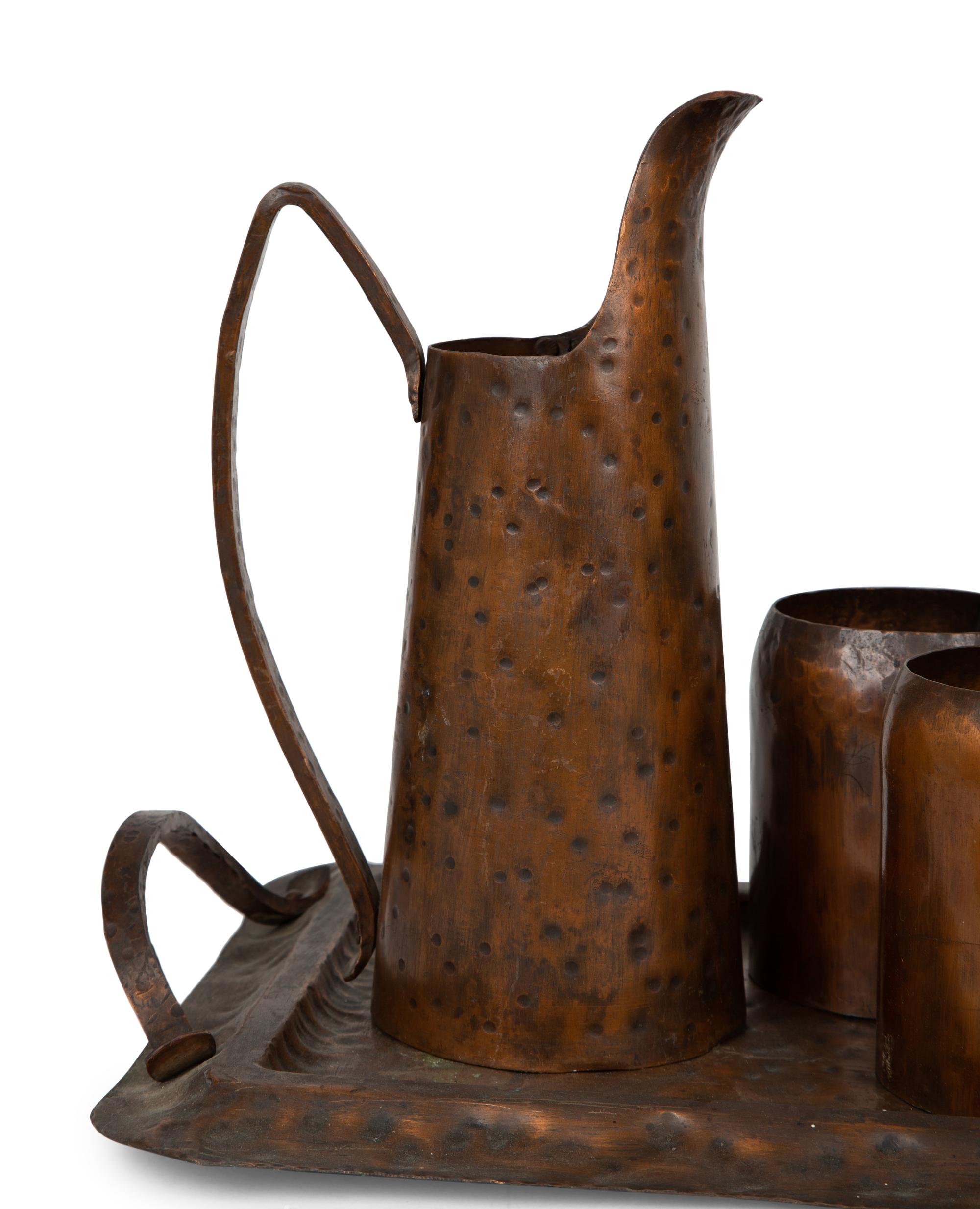 An Arts & Crafts Style Hand Hammered Copper Tray, Pitcher, and Six Mugs — 20TH CENTURY