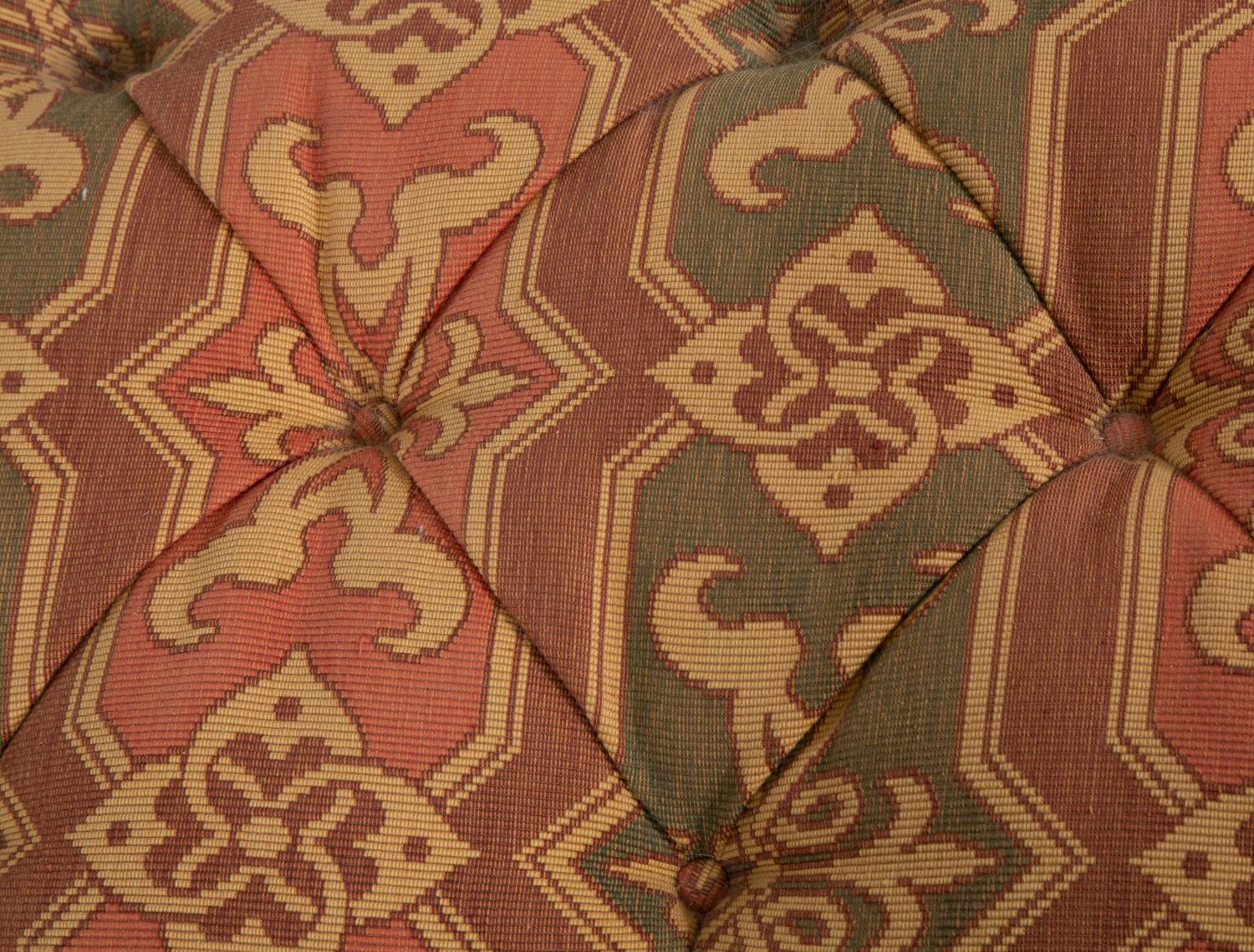 An Upholstered Button Tufted Ottoman with Skirt