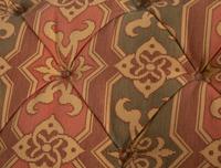An Upholstered Button Tufted Ottoman with Skirt