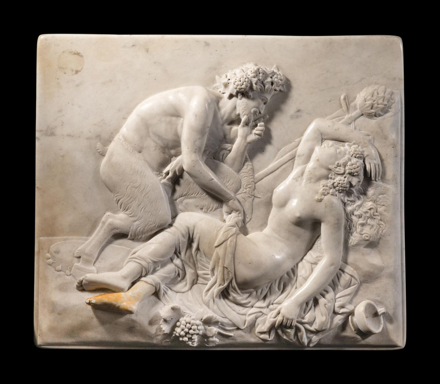 A Continental Carved Marble Relief Depicting a Satyr and a Bacchante