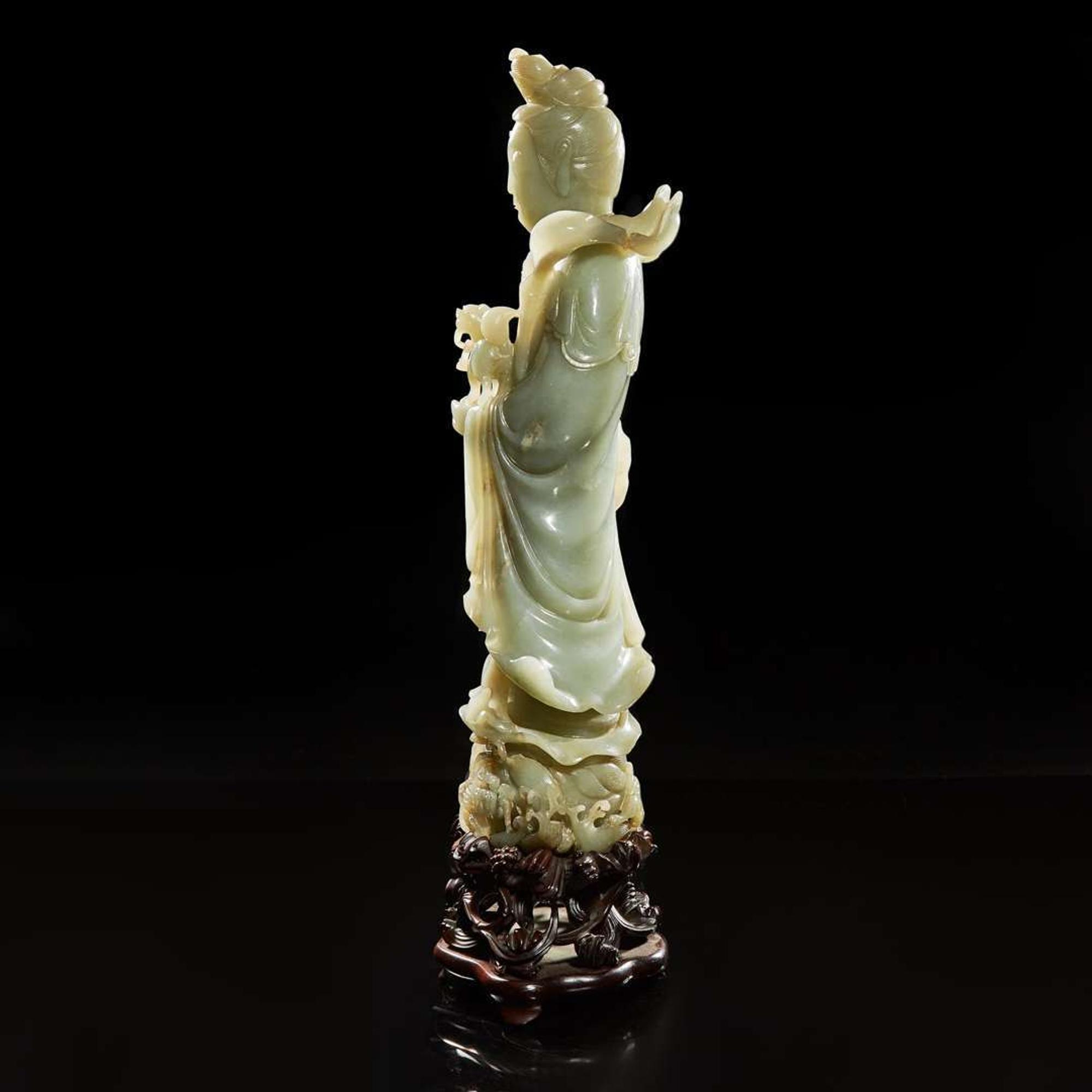 A large Chinese carved celadon jade figure of a bodhisattva 青玉雕觀音 Late Qing to Republic period ?????