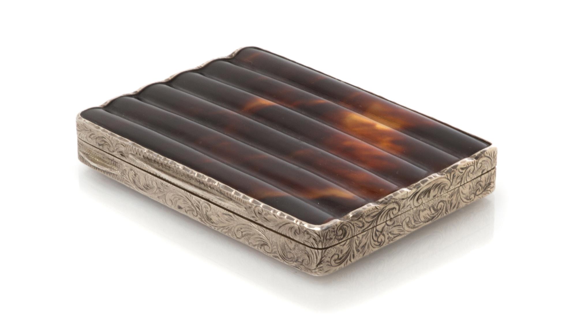 An Austrian Silver and Tortoise-Shell Cigarette Box, Maker's mark obscured, early 20th century, the sides engraved with foliate forms.