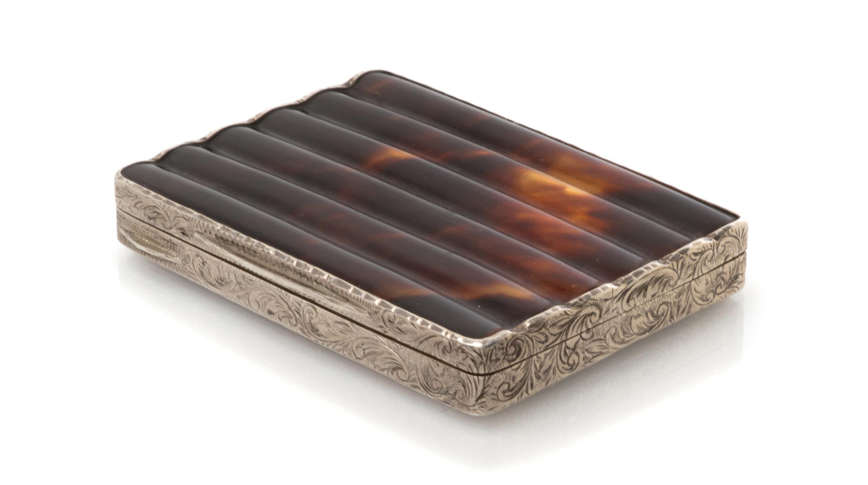 An Austrian Silver and Tortoise-Shell Cigarette Box, Maker's mark obscured, early 20th century, the sides engraved with foliate forms.