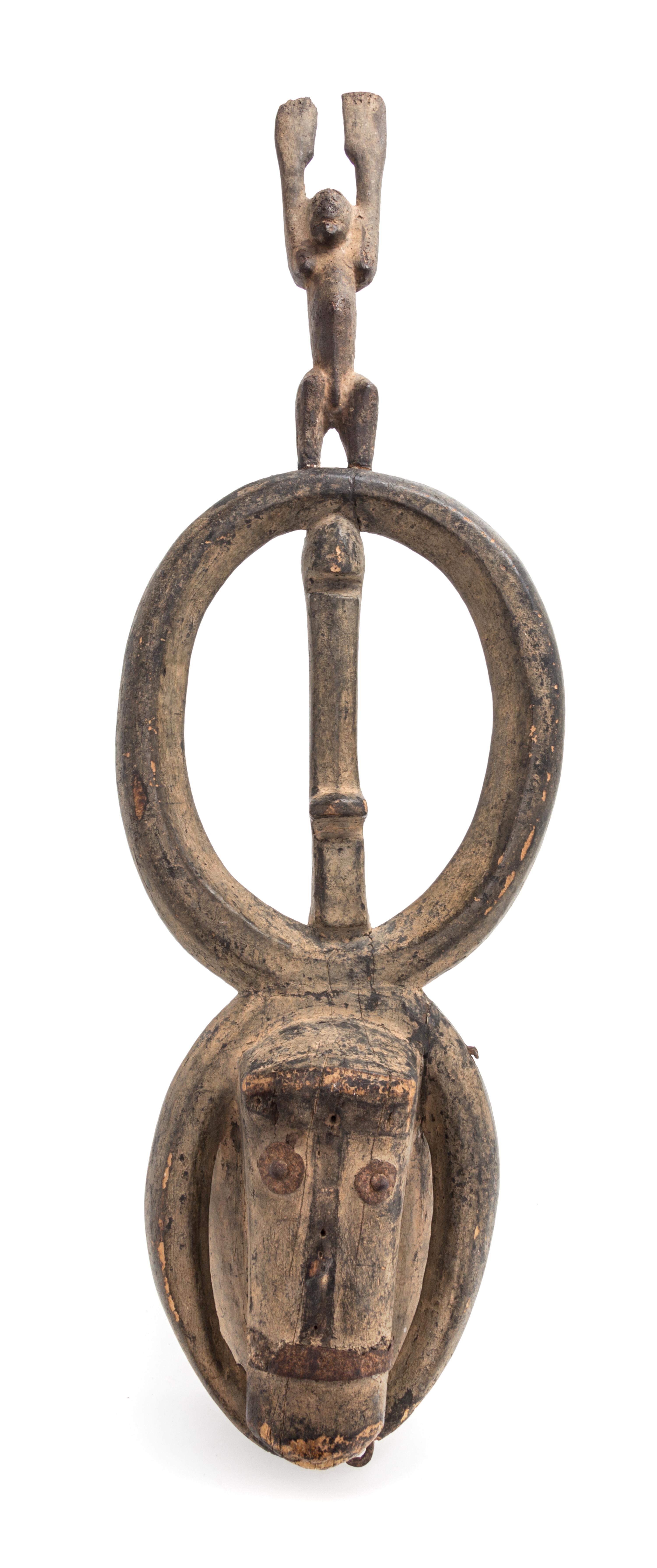 A Dogon Animal Form Wood and Metal Mask Height 30 1/4 x width 7 1/2 x depth 7 inches. — 20TH CENTURY