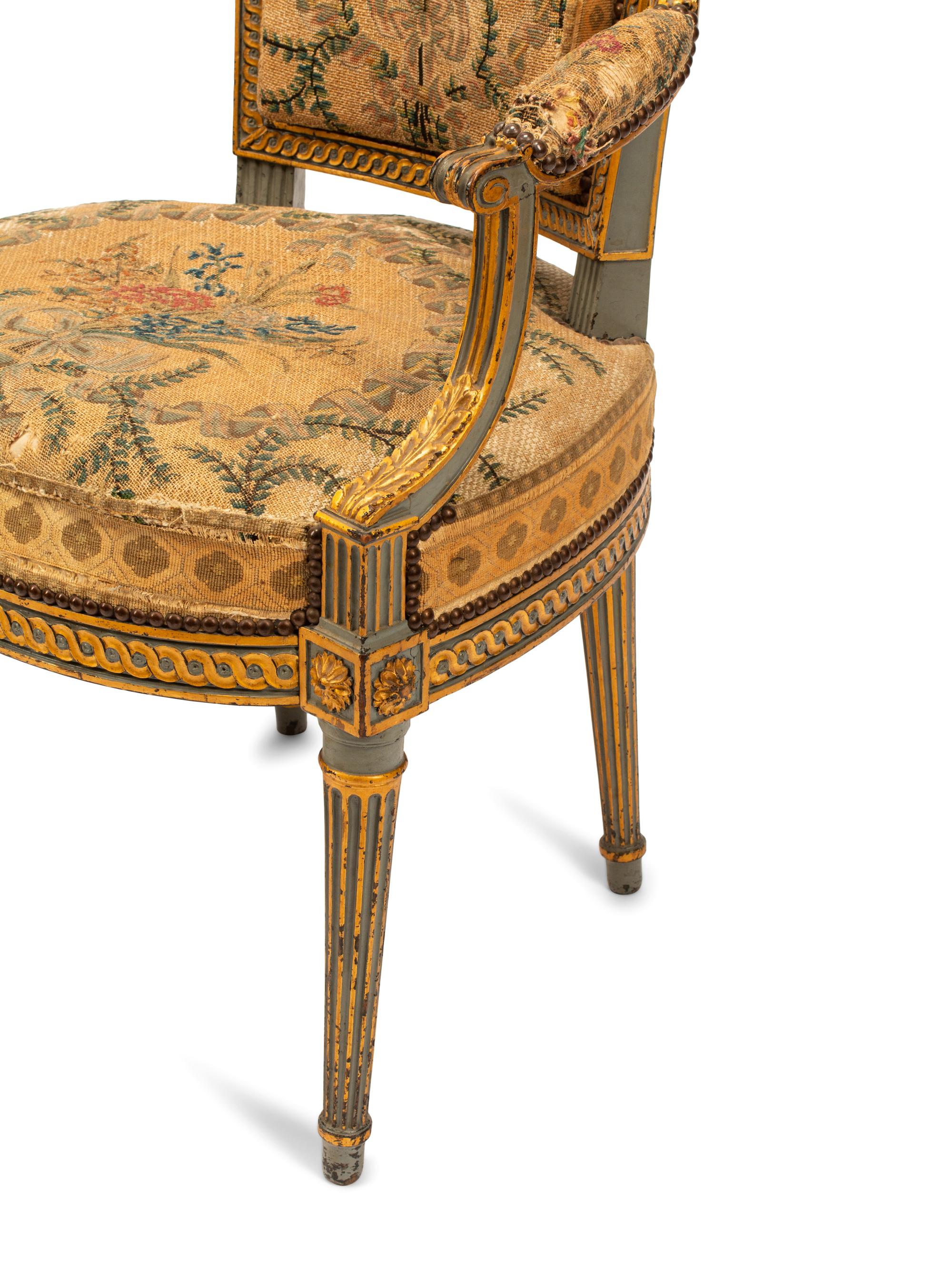 A Pair of French Neoclassical Painted and Parcel Gilt Armchairs