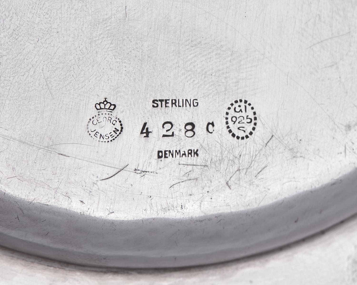 A Set of Twelve Georg Jensen Silver Bread Plates