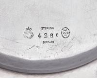 A Set of Twelve Georg Jensen Silver Bread Plates