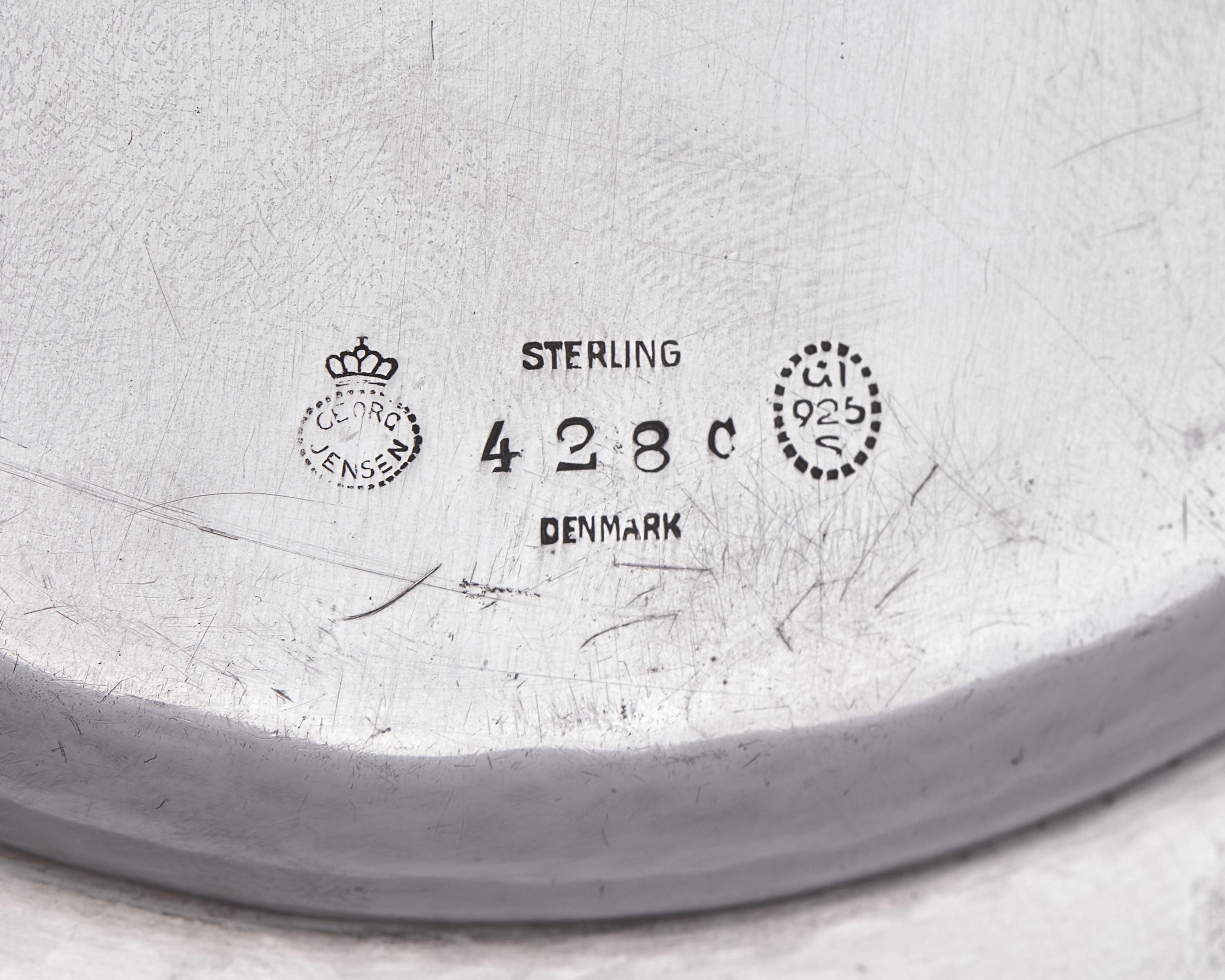 A Set of Twelve Georg Jensen Silver Bread Plates
