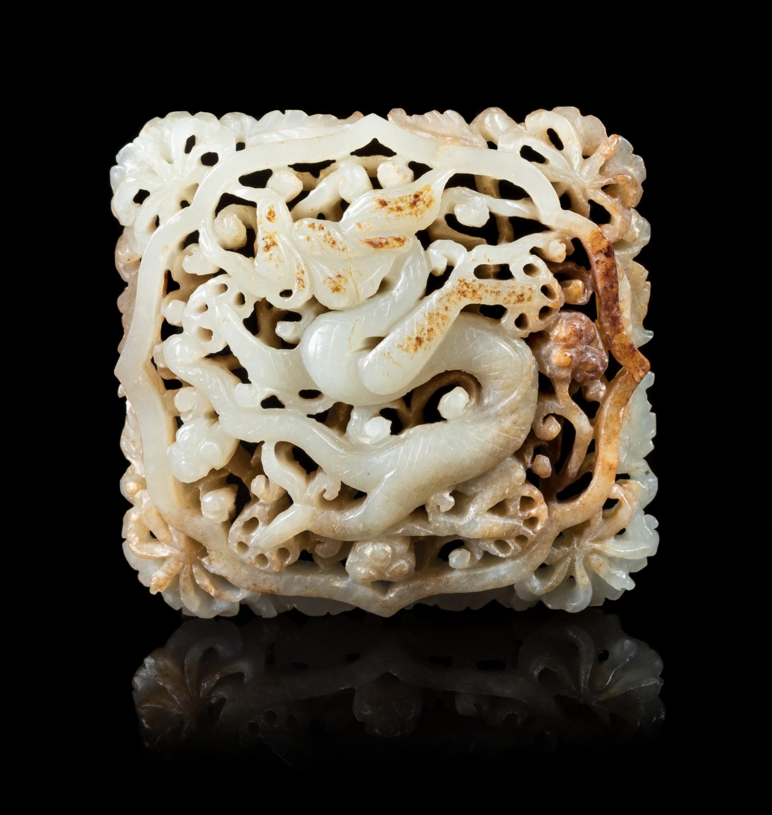 A Celadon and Russet 'Dragon' Jade Plaque Length 2 3/4 inches. — MING DYNASTY, 17TH CENTURY