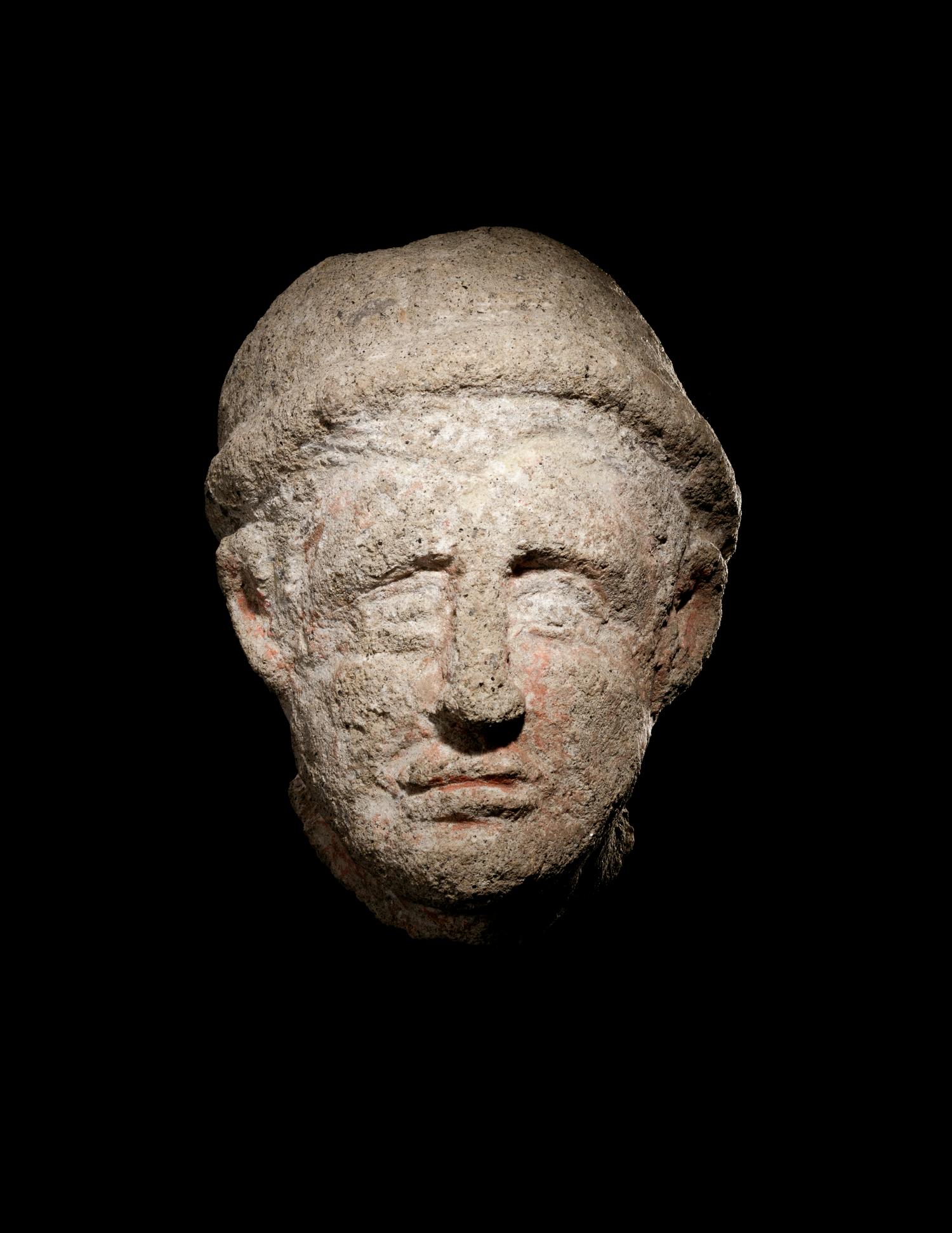 An Etruscan Over-Lifesized Nenfro Portrait Head of a Man