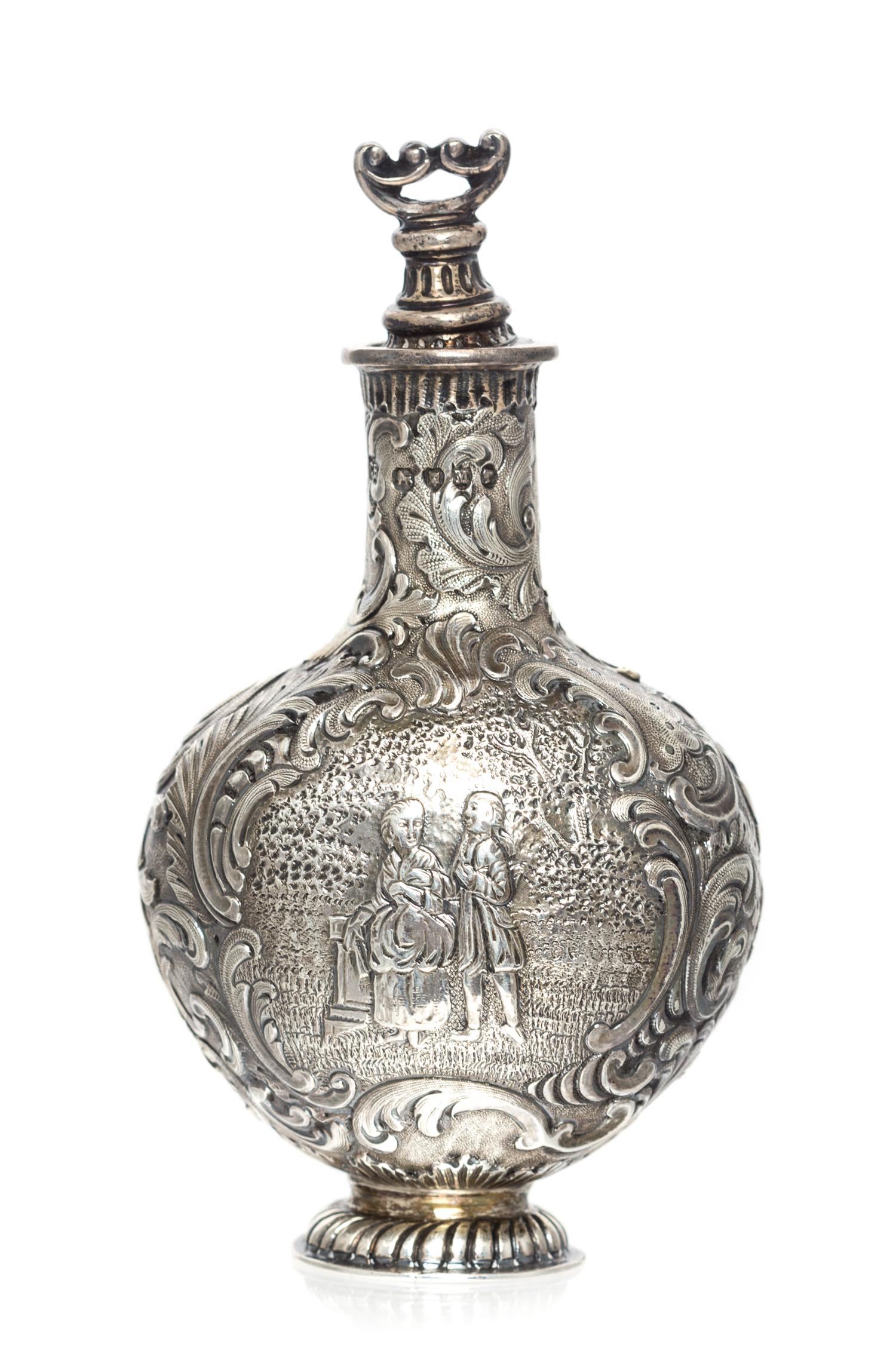 A Victorian Silver Scent Bottle, Likely Charles Engelhard, London, 1887, the body worked to show a courting couple in a garden within a