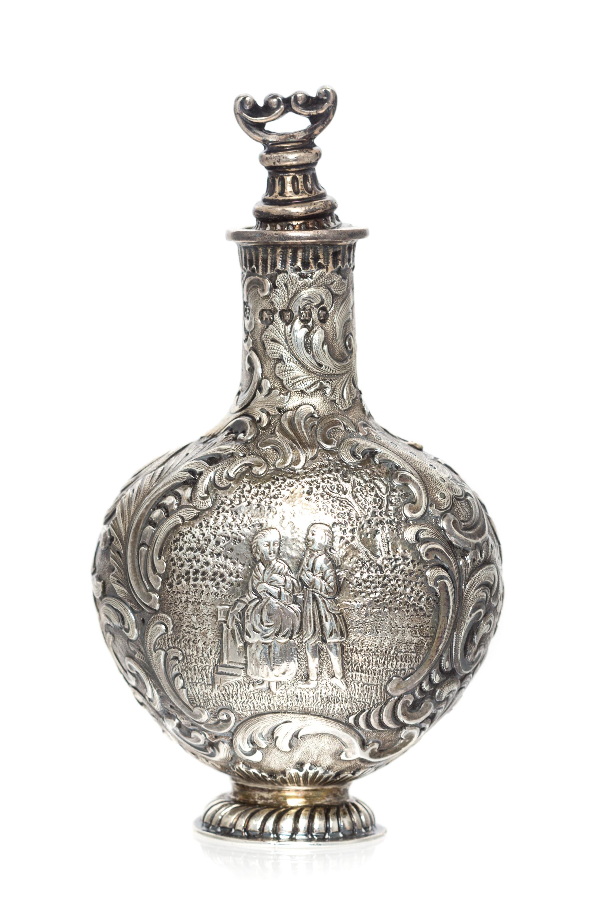 A Victorian Silver Scent Bottle, Likely Charles Engelhard, London, 1887, the body worked to show a courting couple in a garden within a