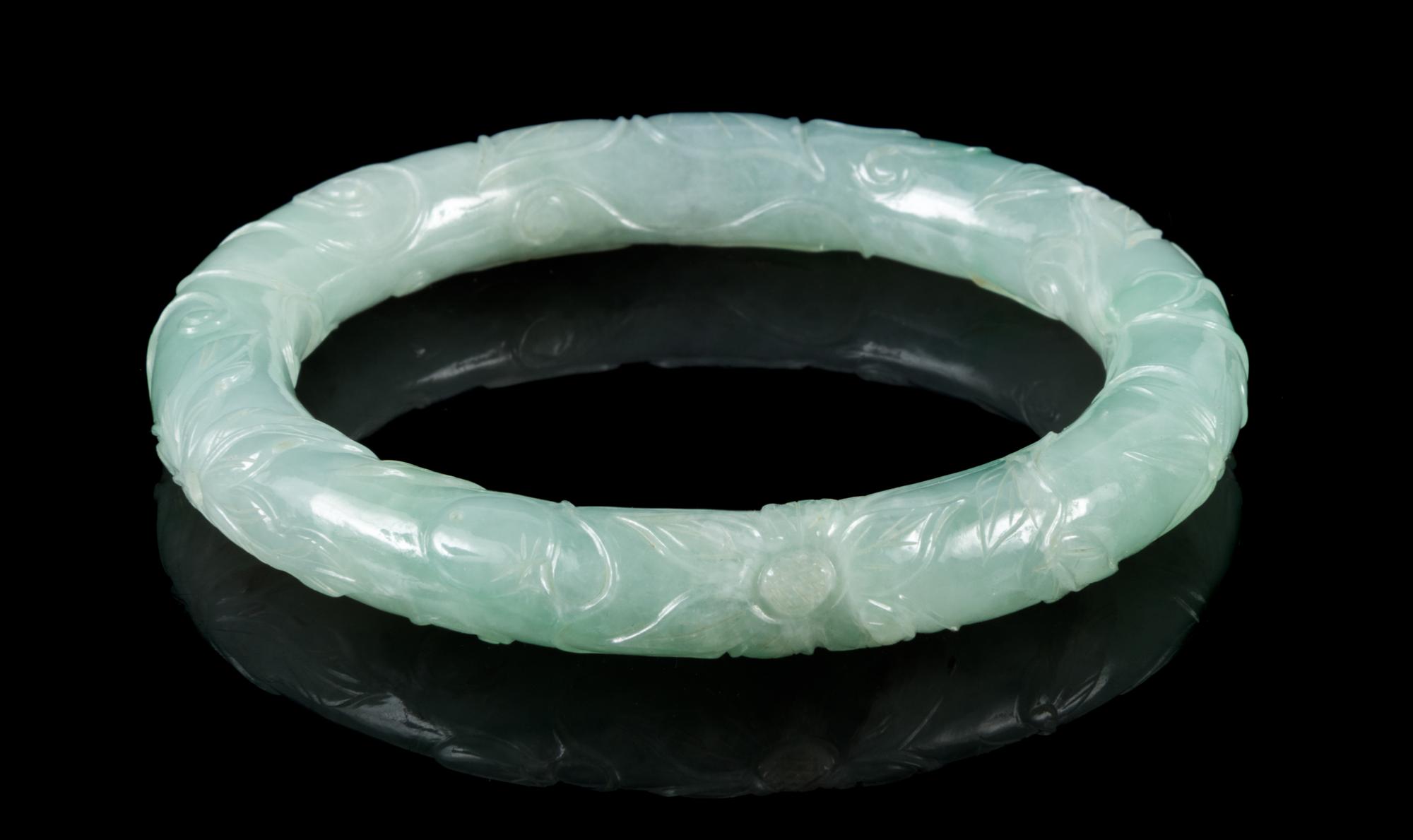 An Apple Green and Celadon Jadeite Bangle Interor diameter 2 1/4 inches.