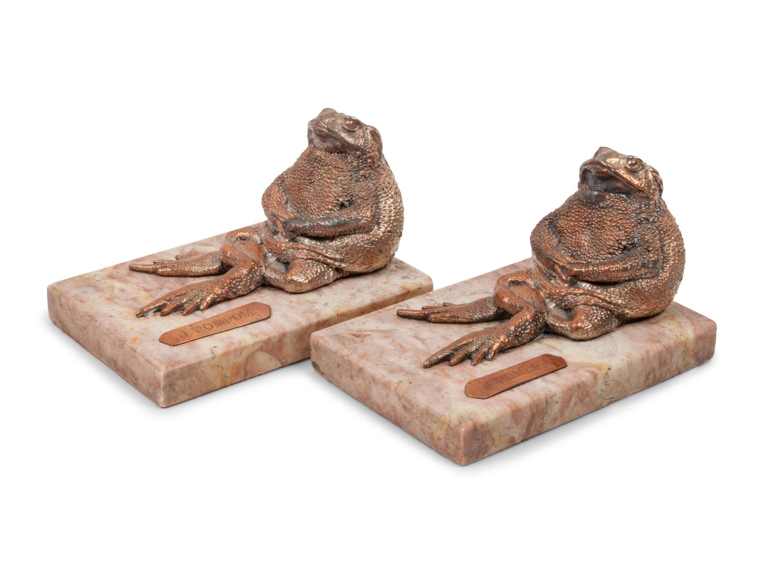 A Pair of Silvered Copper and Marble Bookends