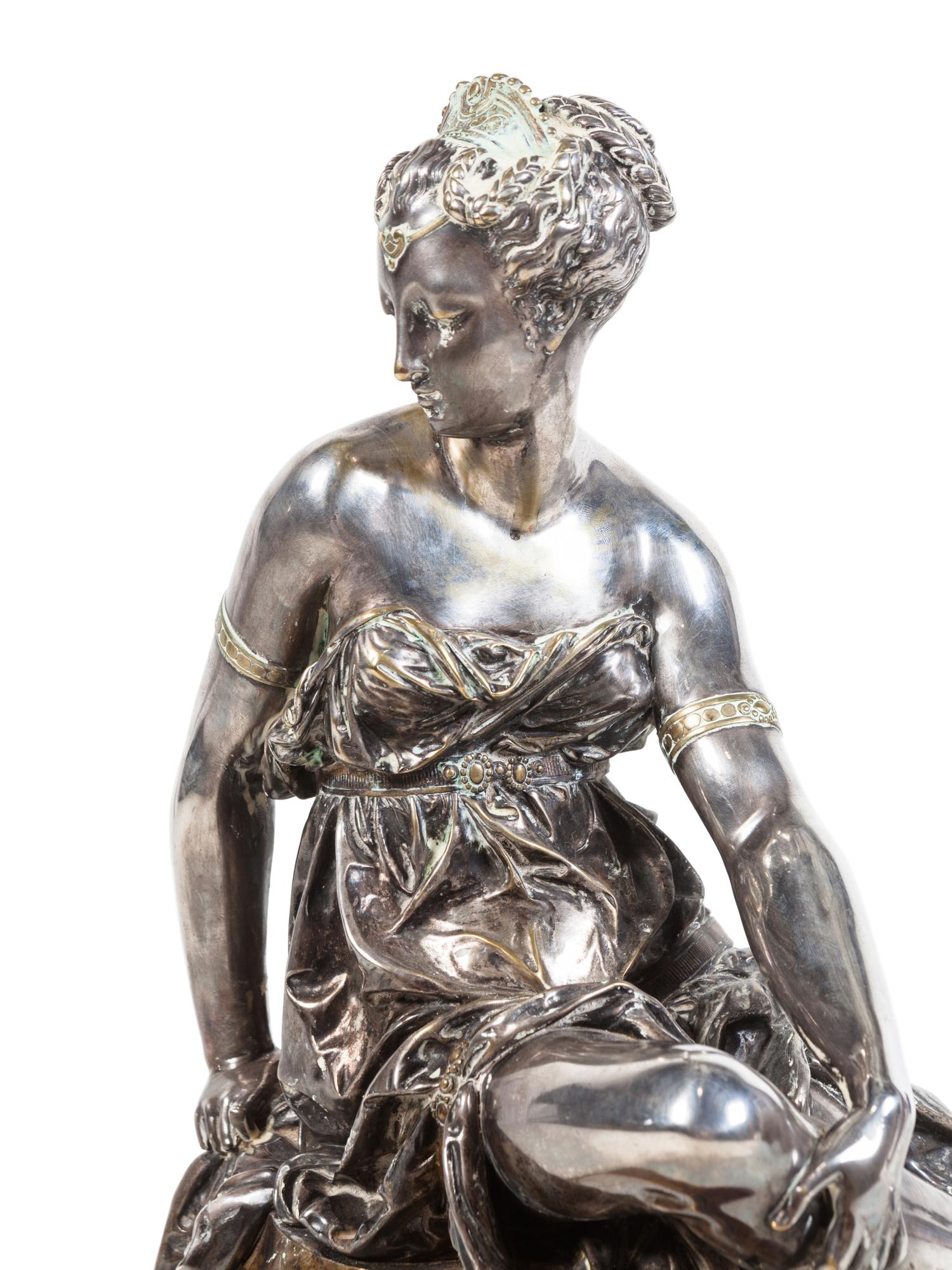 A Napoleon III Gilt and Silvered Bronze and Rouge Griotte Marble Figural Clock