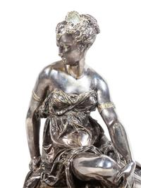 A Napoleon III Gilt and Silvered Bronze and Rouge Griotte Marble Figural Clock