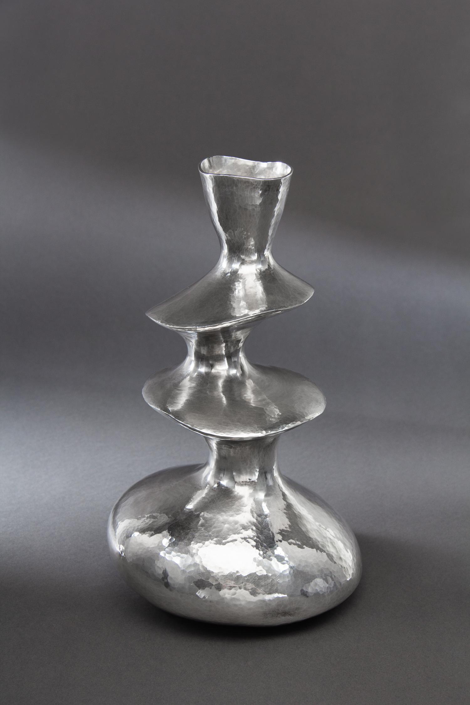 A Contemporary English Silver Vase, Hiroshi Suzuki, Sheffield, 2002, of three tiered from with a spot-hammered finish throughout.