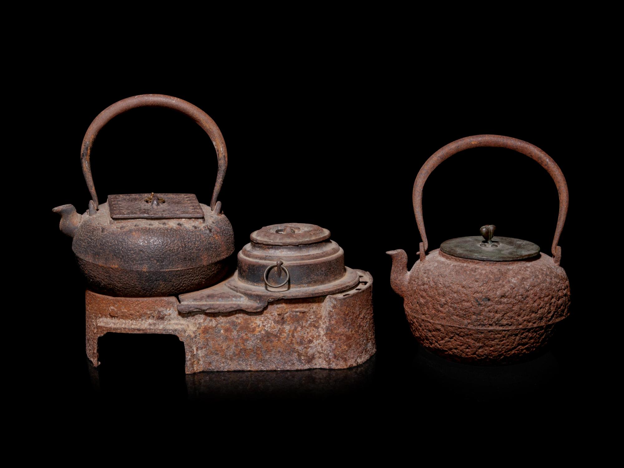 Seven Japanese Cast Iron Teapots, Tetsubin, and Burner