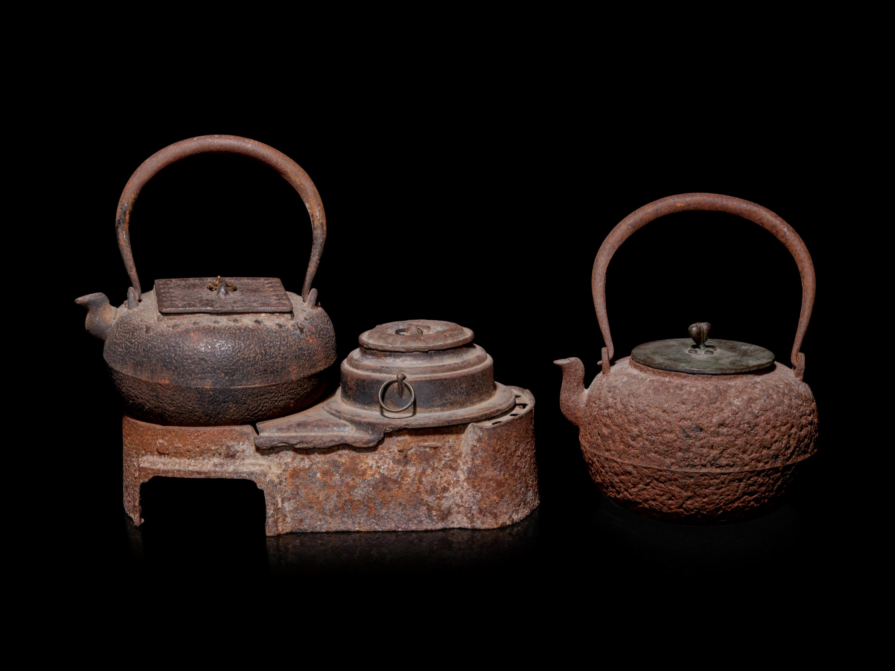 Seven Japanese Cast Iron Teapots, Tetsubin, and Burner