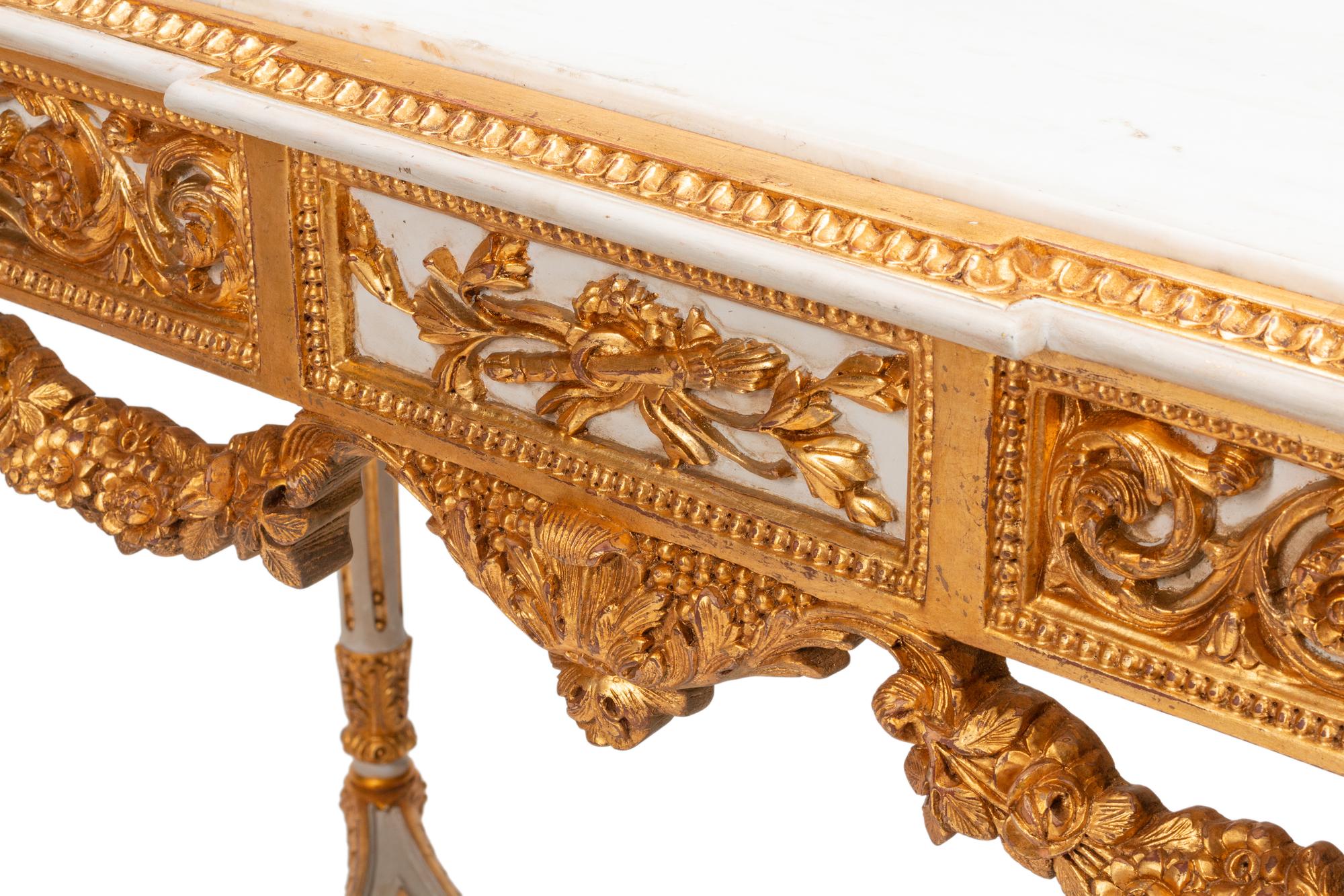 A Pair of Louis XVI Style White Painted and Parcel Gilt Marble-Top Console Tables