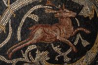 A Roman-Style Polychrome Mosaic Panel with a Bearded Head and Two Animals