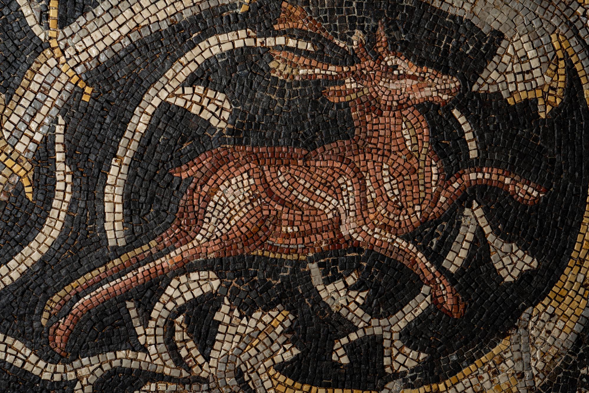 A Roman-Style Polychrome Mosaic Panel with a Bearded Head and Two Animals