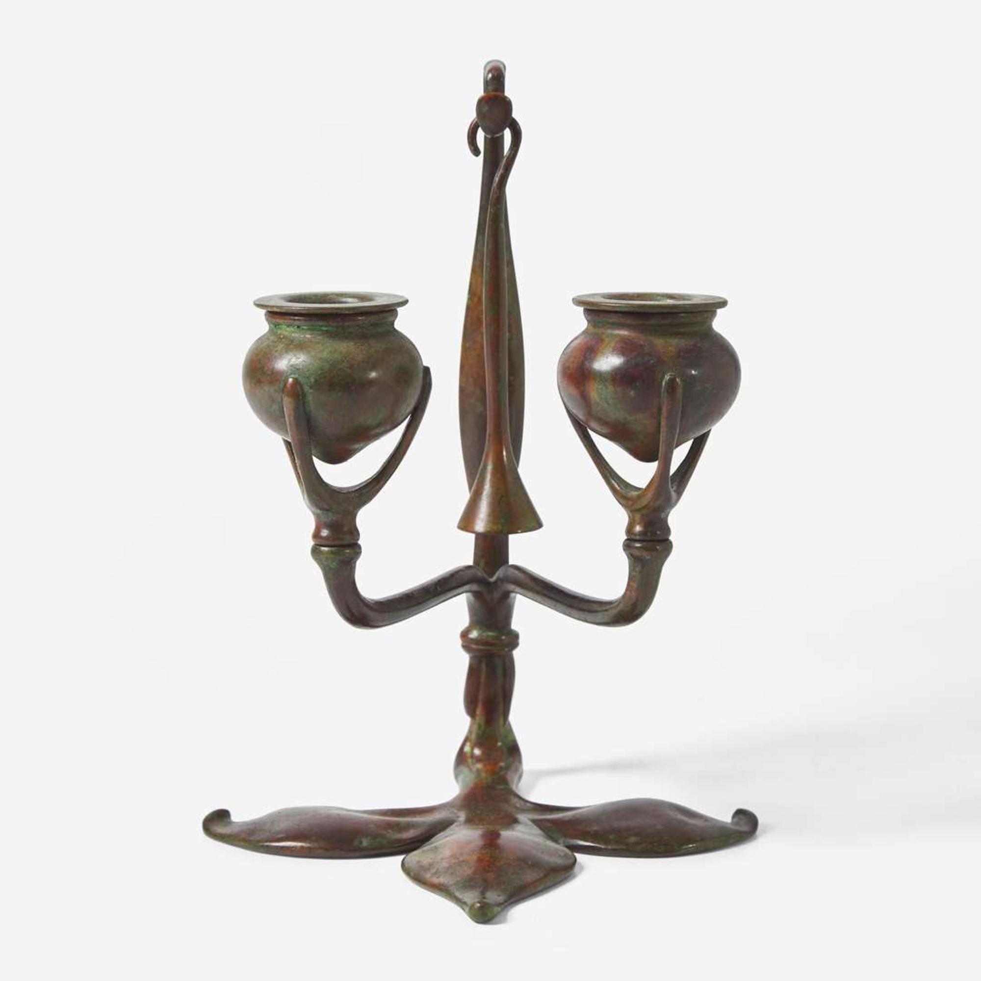 Tiffany Studios (American, active 1878-1932) A Bronze "Fleur de Lis" Two-Light Candelabra with Snuffer, USA, circa 1910