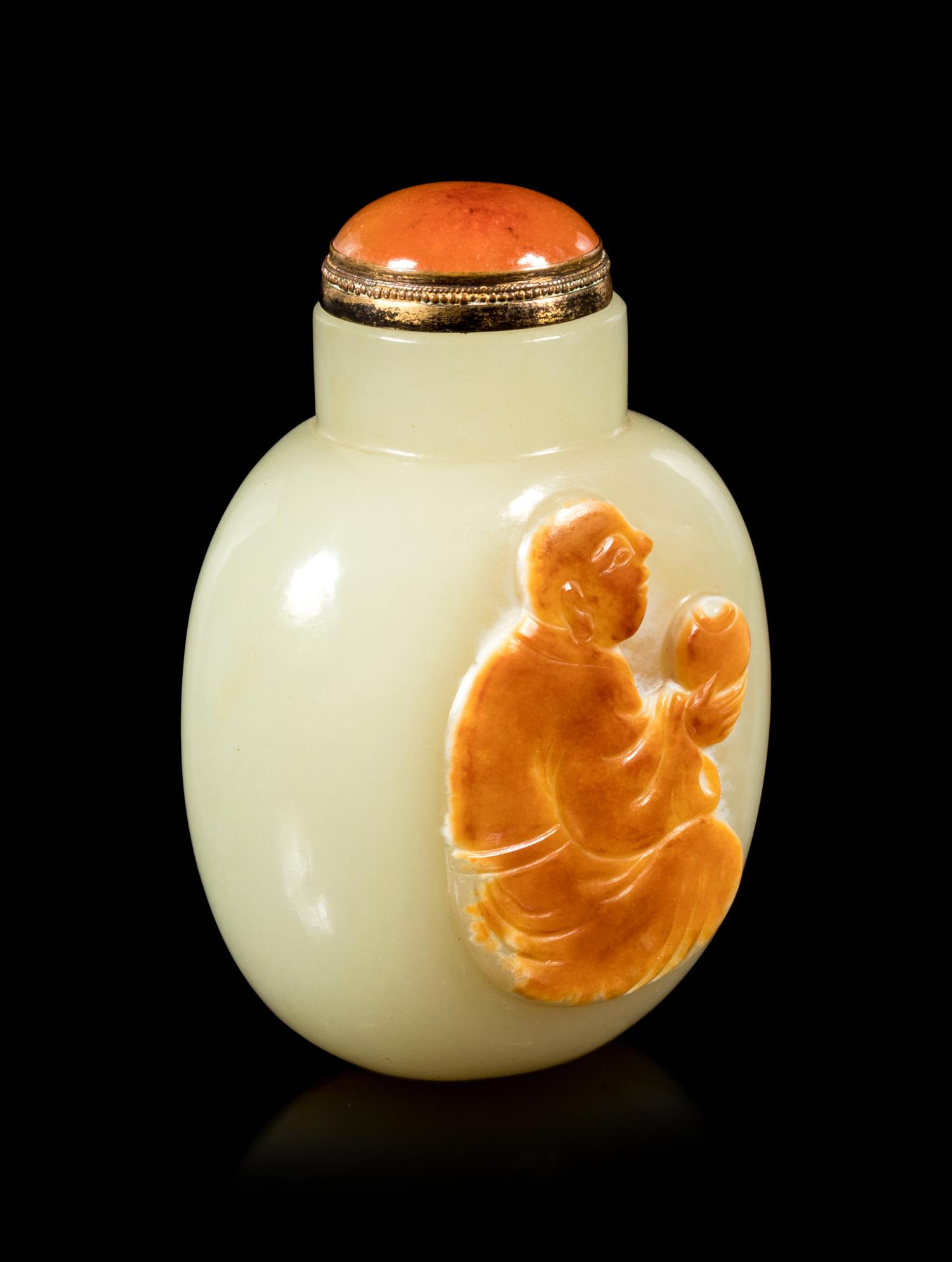 A Carved Russet and Celadon Jade Snuff Bottle