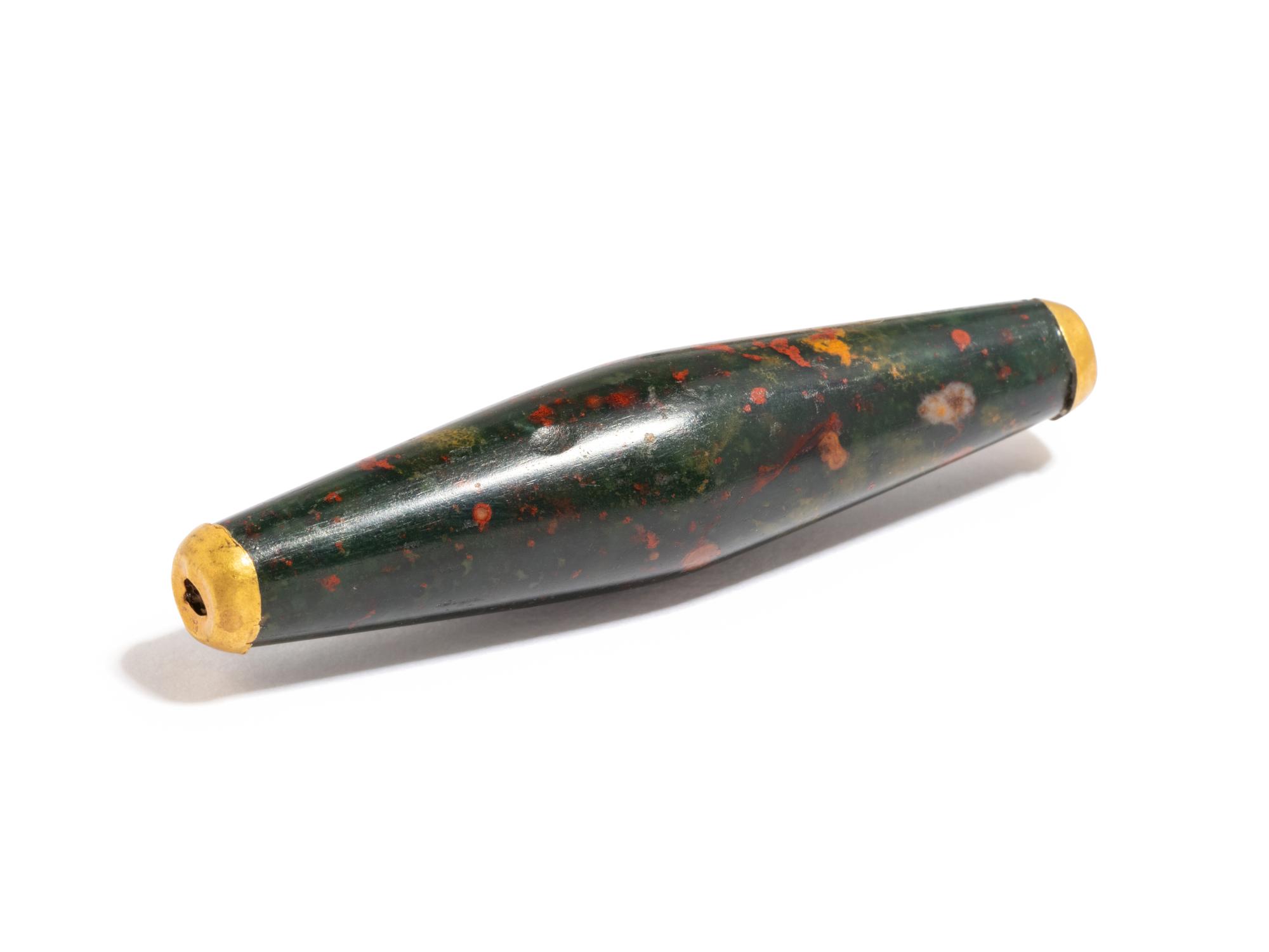 A Near Eastern Bloodstone Bead with Gold Caps