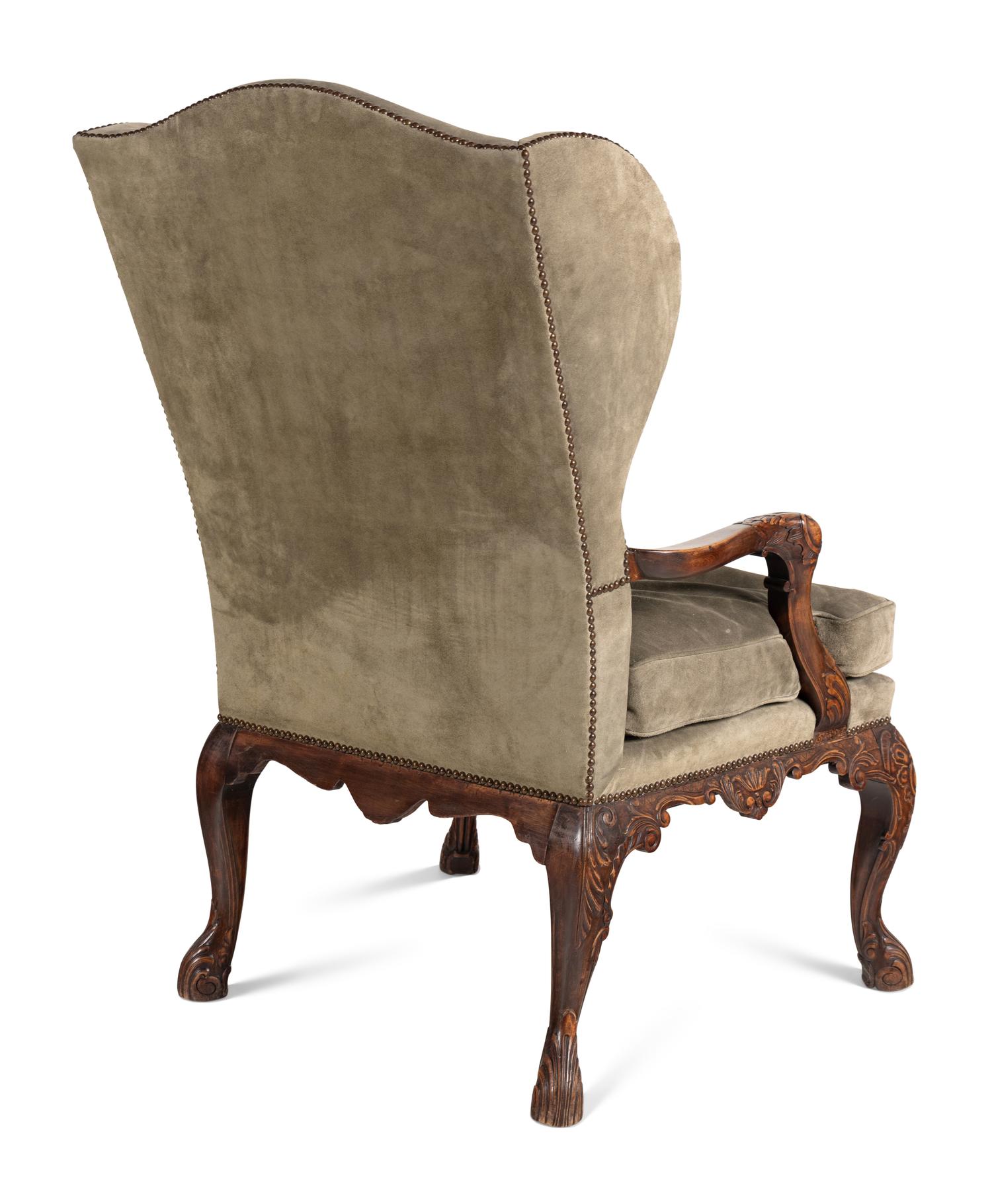 A Pair of Régence Style Suede Upholstered Walnut Wingback Fauteuils