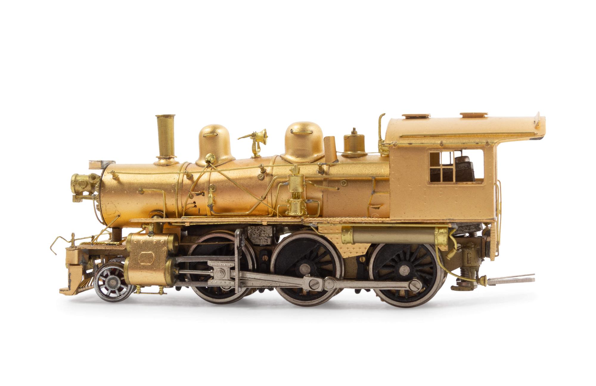 A Group of Four Brass Locomotives and Three Tenders