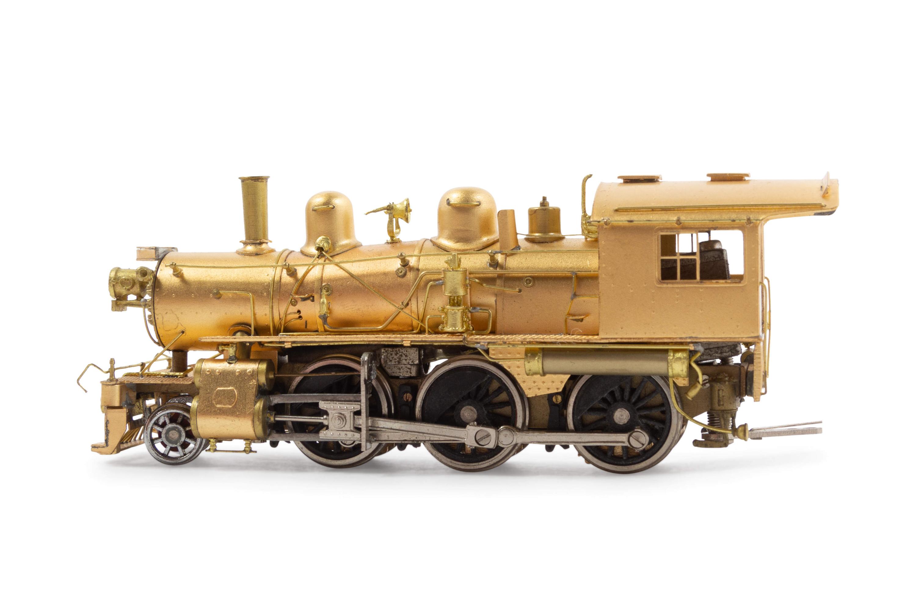 A Group of Four Brass Locomotives and Three Tenders