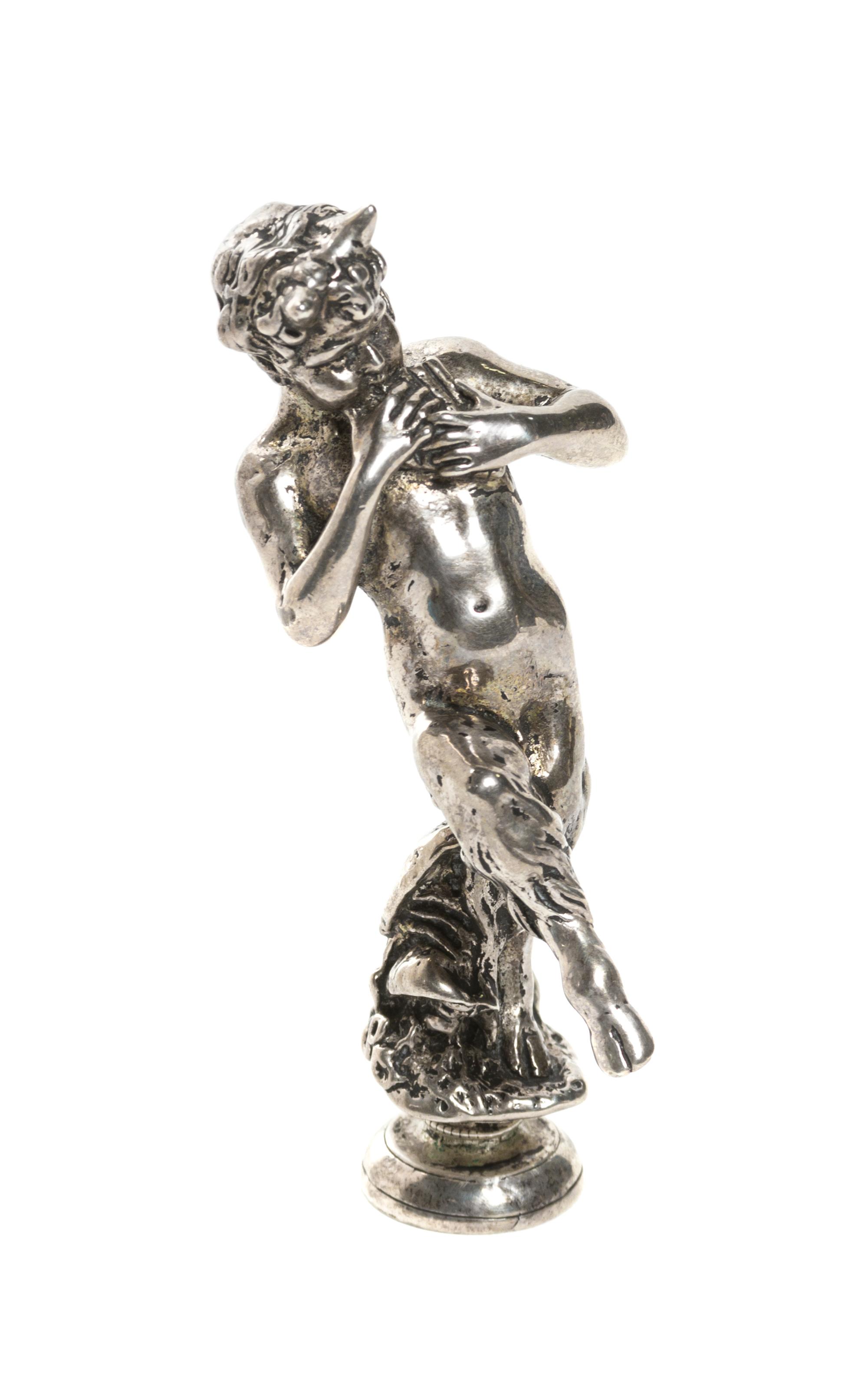 A Continental Silvered Metal Figural Seal, Height 3 1/4 inches.