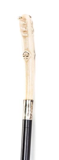 An American Inuit Carved Walrus Ivory Handled Walking Stick, Length of handle 5 3/4 x length overall 34 1/2 inches.