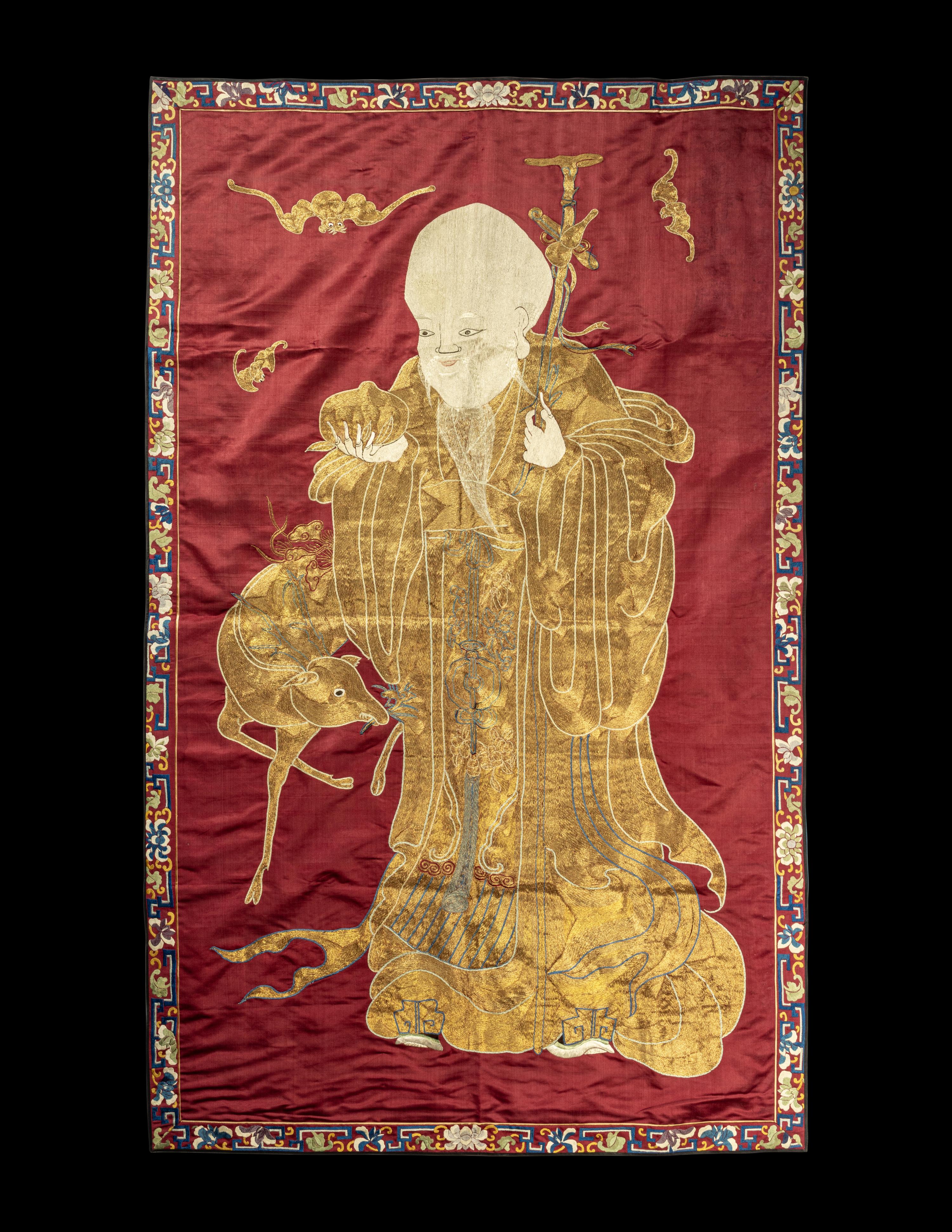 A Large Chinese Red Ground Embroidered Silk 'Longevity' Panel