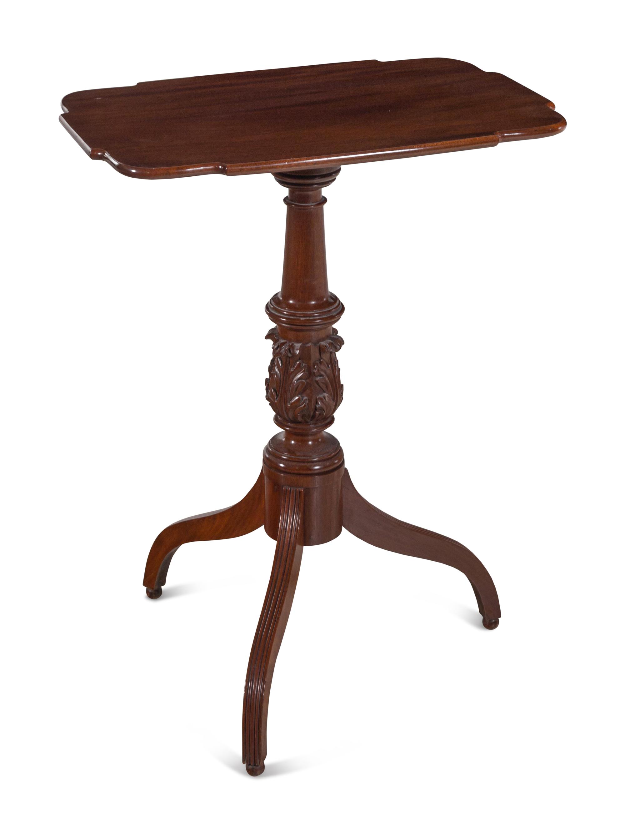 A Late Federal Carved and Figured Mahogany Shaped Top Candlestand
