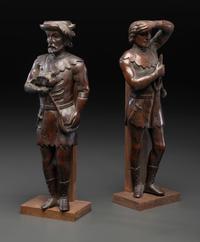 A Pair of Continental Carved Oak Huntsman Figures