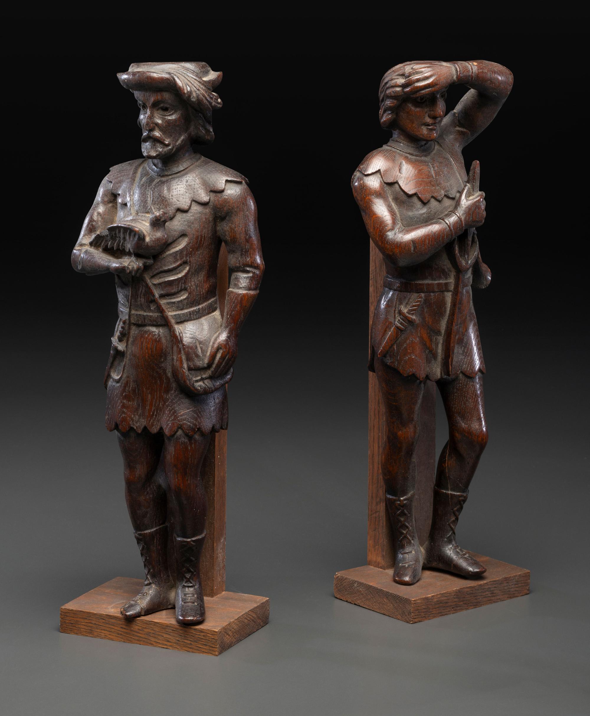 A Pair of Continental Carved Oak Huntsman Figures