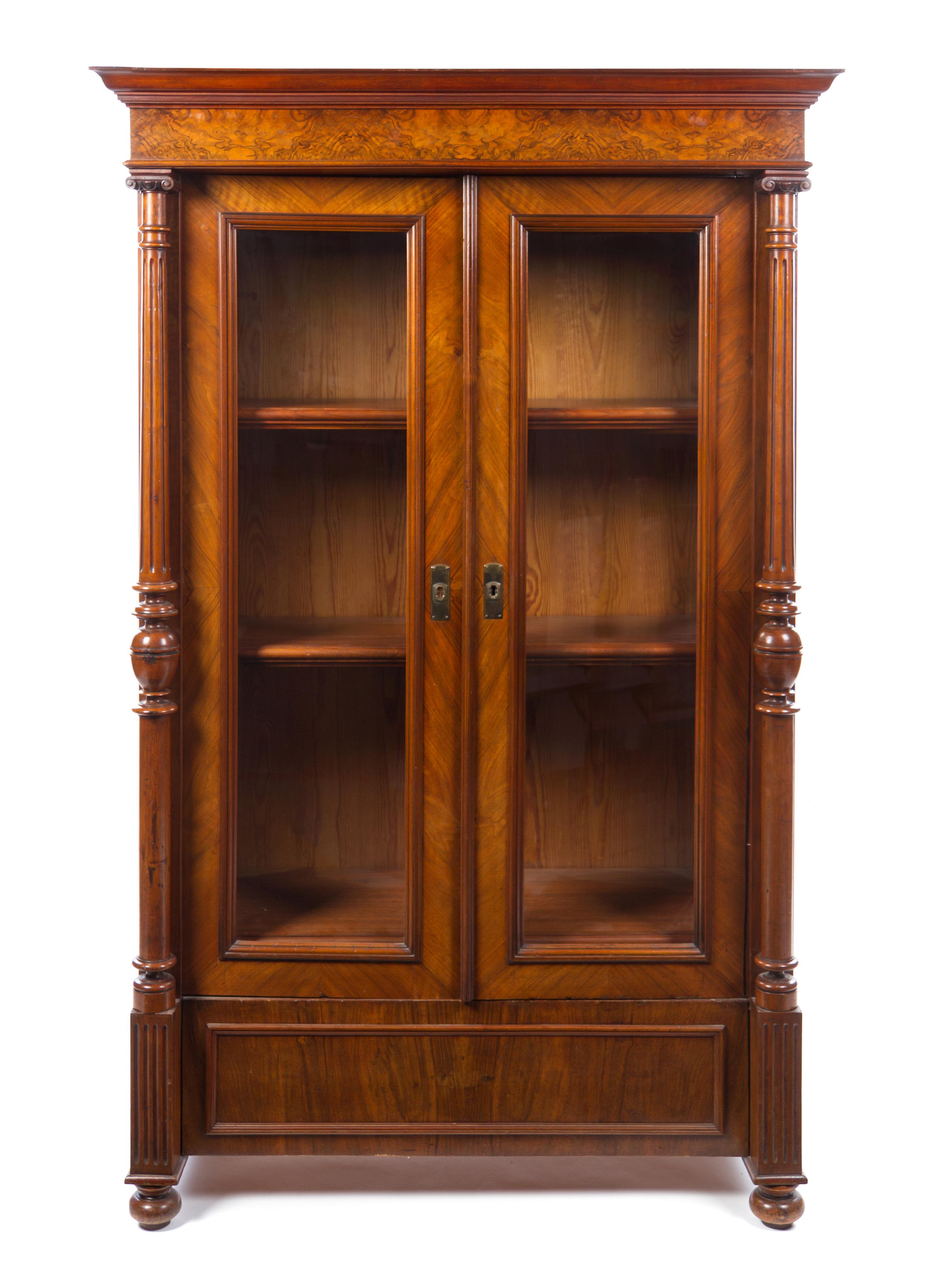A German Neoclassical Walnut Bookcase Height 73 1/2 x width 46 1/4 x depth 22 1/4 inches. — LATE 19TH CENTURY