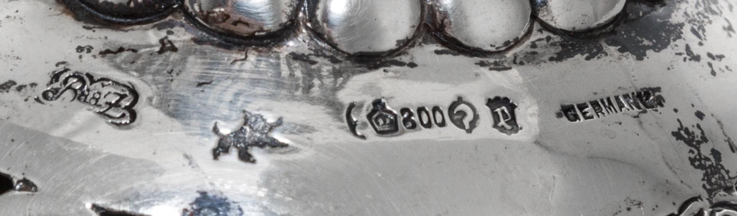 A Set of Three German Silver Goblets, 19th/20th Century, each pierced bowl with four vacant cartouches, raised on a figural stem in the
