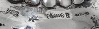 A Set of Three German Silver Goblets, 19th/20th Century, each pierced bowl with four vacant cartouches, raised on a figural stem in the
