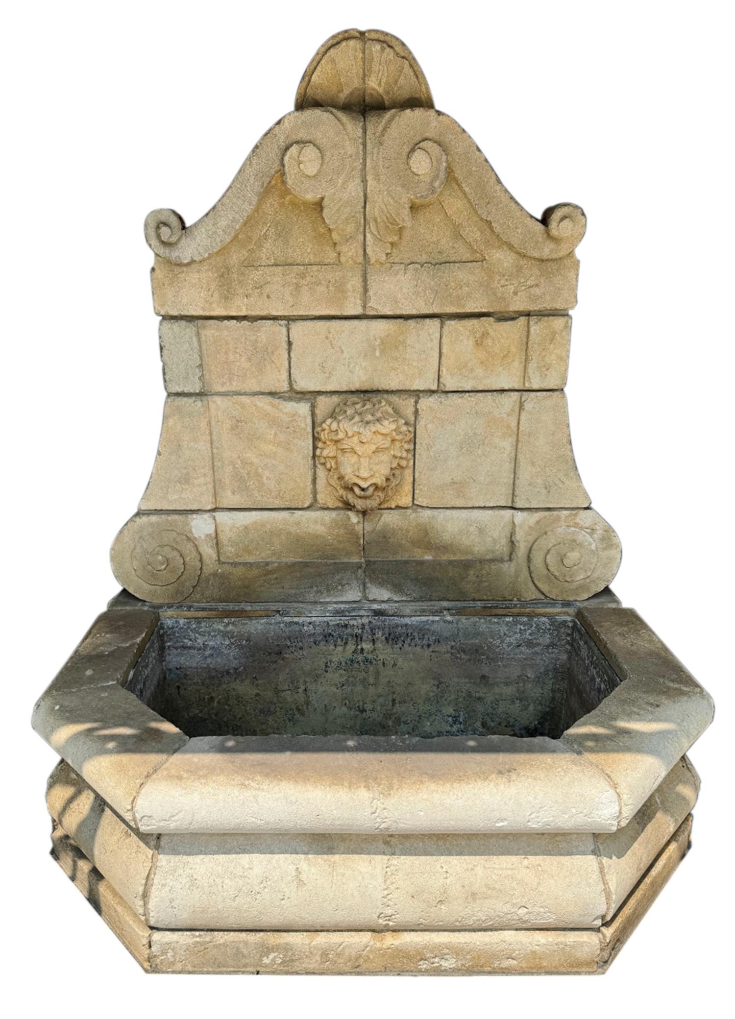 A Neoclassical Carved Limestone Wall Fountain
