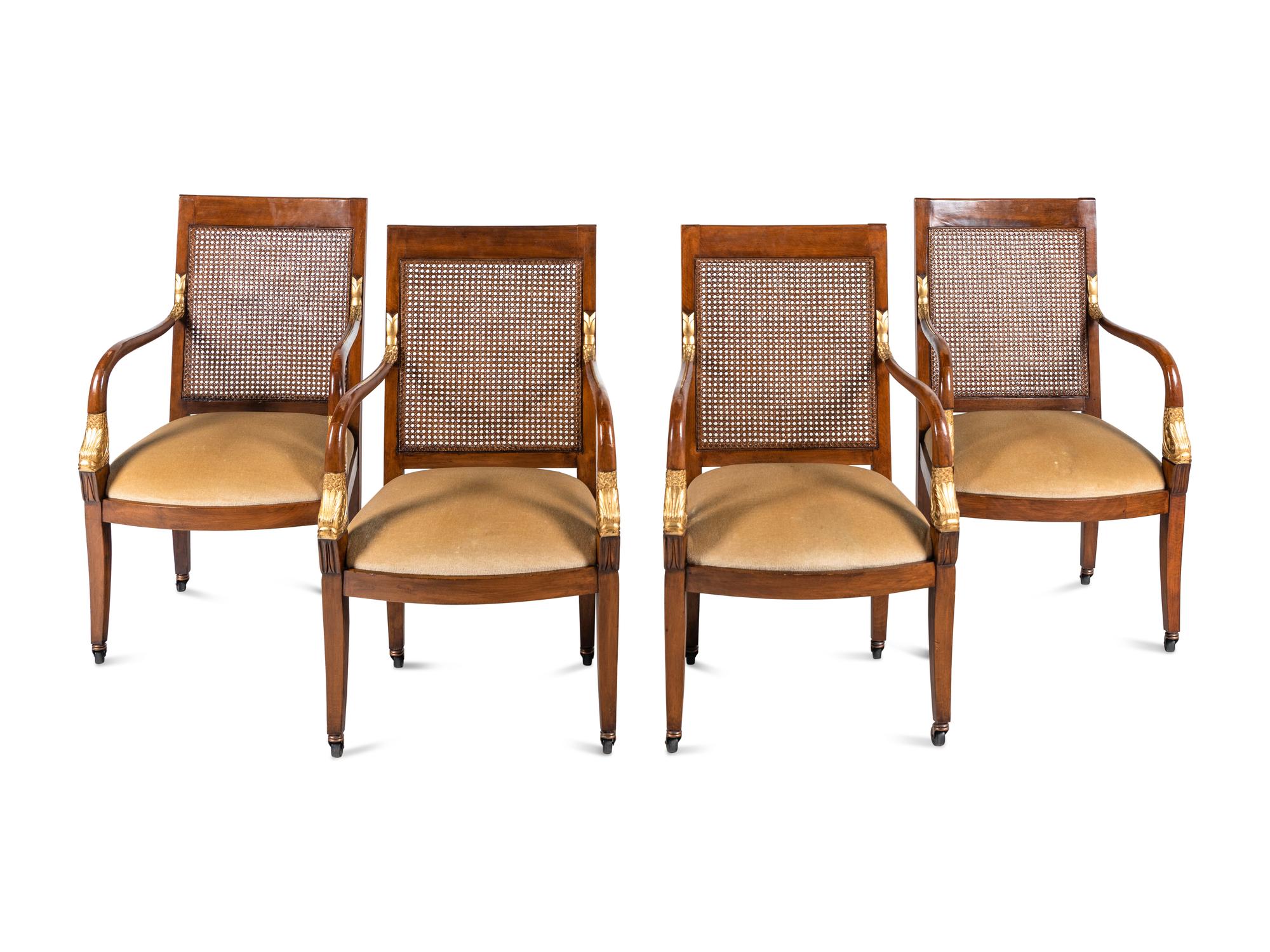 A Set of Four Baltic Style Parcel Gilt Walnut Armchairs