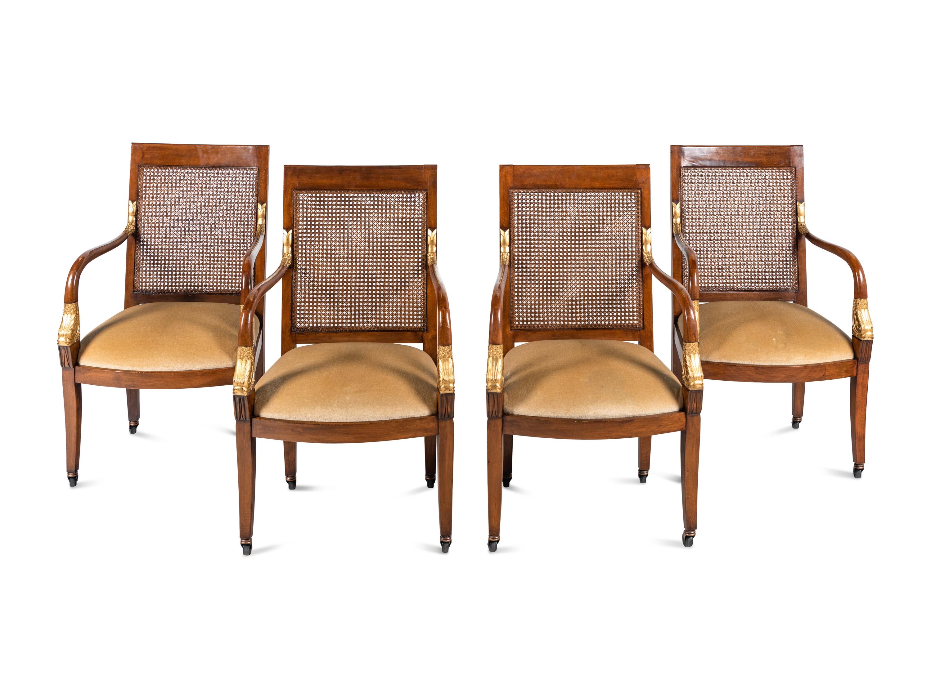 A Set of Four Baltic Style Parcel Gilt Walnut Armchairs