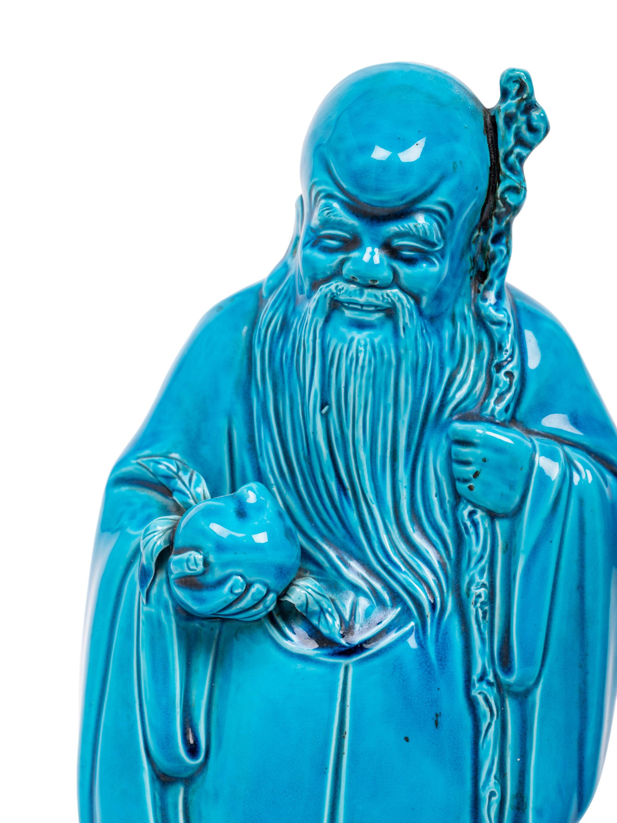 Two Turquoise Glazed Porcelain Figures of Immortals