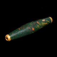 A Near Eastern Bloodstone Bead with Gold Caps