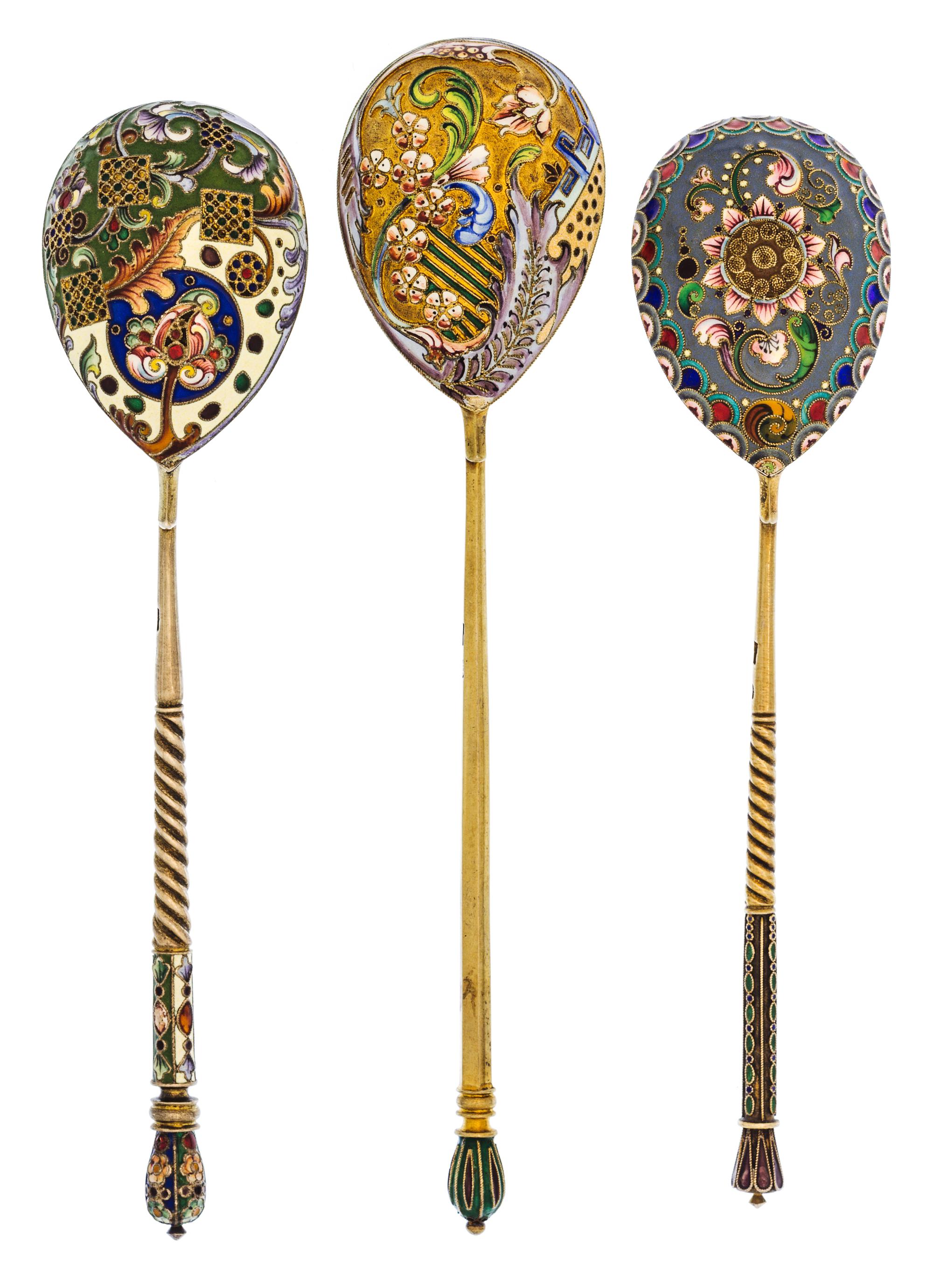 A Group of Three Russian Silver-Gilt and Enamel Spoons, Mark of 11th Artel, Moscow, early 20th century, each having an enameled finial,