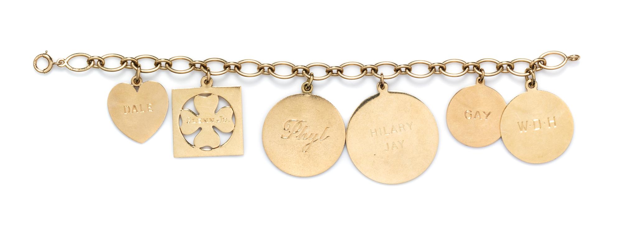 A 14 Karat Yellow Gold Charm Bracelet with Six Attached Charms, 29.10 dwts.